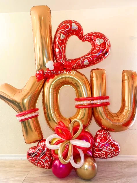 Celebrate Love on Valentine's Day in Brooklyn with Gold "Love" Letter Balloon, White, Red, Gold Twisted Balloons, Heart-Shaped Balloon, and Gold/Pink Balloon Cluster