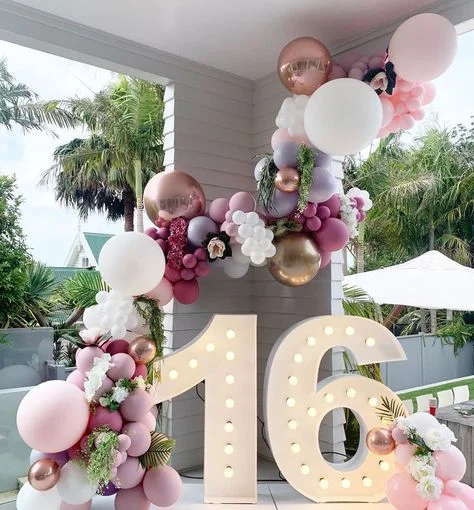 A colorful Sweet 16 balloon garland featuring pink, purple, rose gold, and white balloons, ready to celebrate in New Jersey
