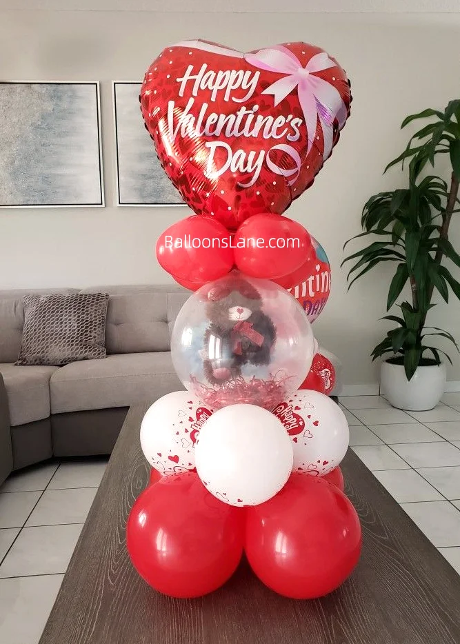Balloon columns with red heart balloons, white and red latex balloons, clear balloon with bear inside, and red latex balloon in Brooklyn.