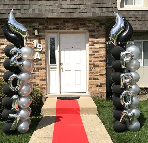 A black and white latex balloon column featuring Foil "PROM" letter balloon and number balloons.