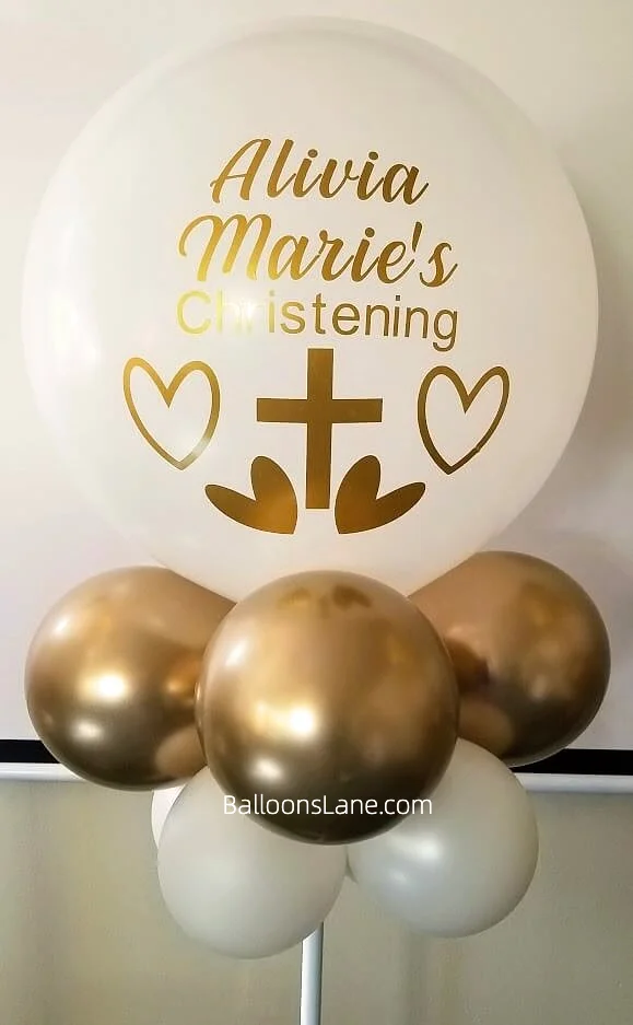 Baptism customized balloons featuring a bouquet of gold and white balloons in Brooklyn.