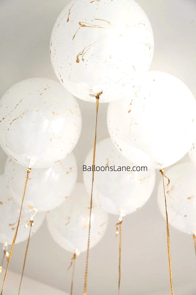 Large white and gold marble balloons by Balloons Lane
