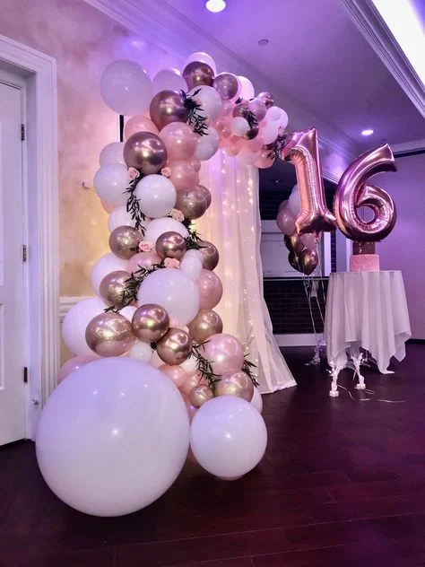 Sweet 16 celebration with balloon backdrops in pink, gold, and white balloons of all sizes in NYC.