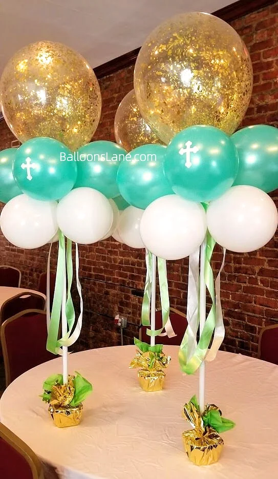 A bouquet featuring a large gold confetti balloon and sea green christening balloons, arranged to celebrate a christening in NYC.