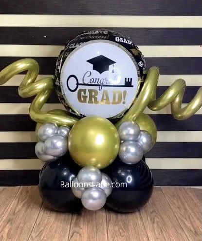 grad balloon along with gold twisted balloon and silver black balloon to celebrate graduation in NYC