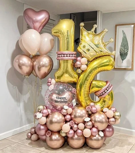 A king-style balloon arrangement featuring number 1 and 6 balloons, a customized confetti balloon, pink and rose gold balloons, a heart-shaped balloon, and chrome pink balloons for an extraordinary 16th birthday celebration in NJ.