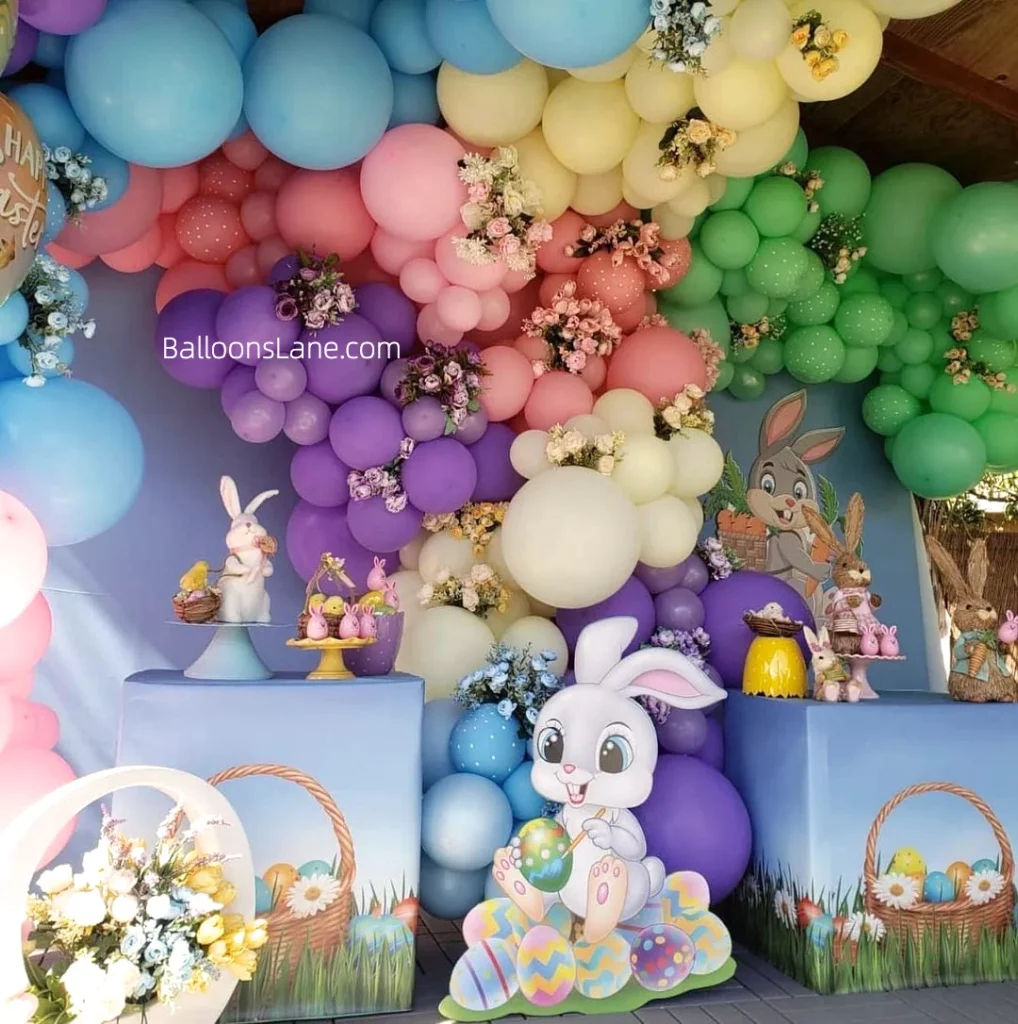 A joyful Easter balloon backdrop in white and pink, enhanced by green, white, yellow and purple latex balloons, is set in New Jersey.