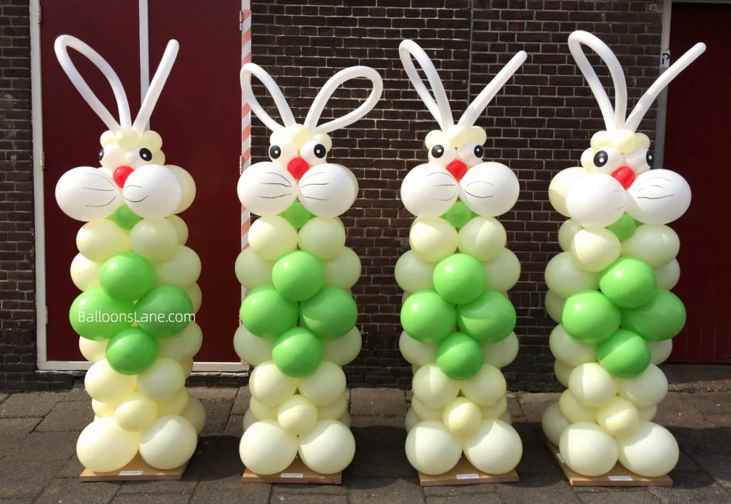 A lively Easter Bunny balloon column made from twisted and latex balloons in green, white, yellow, and red, set against a Brooklyn backdrop