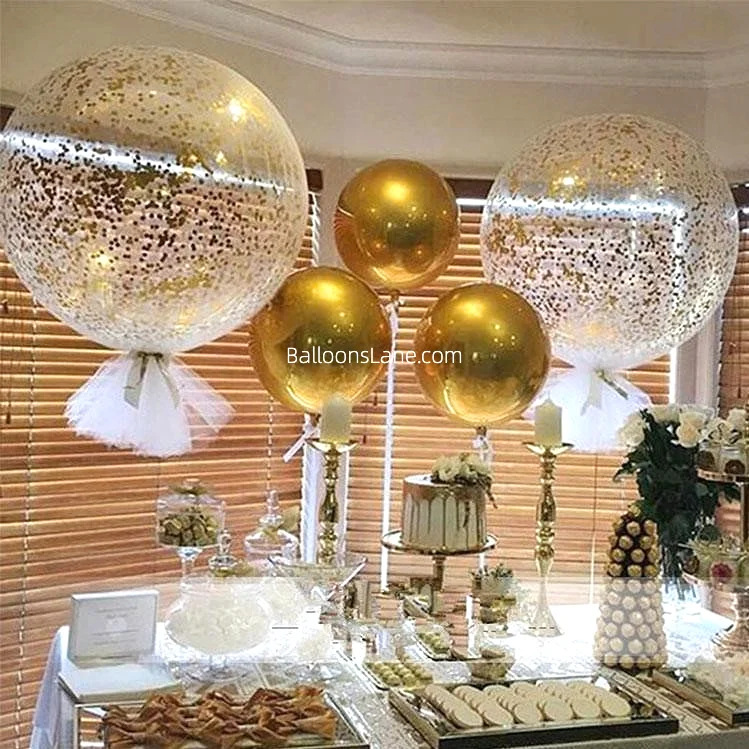 Desert theme table decor with large white and gold confetti balloons in Brooklyn