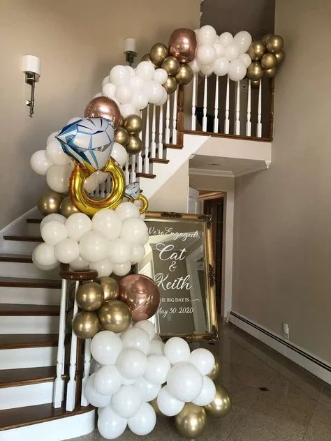 A balloon garland featuring white, gold, and rose gold balloons with a gold foil ring balloon, in NYC