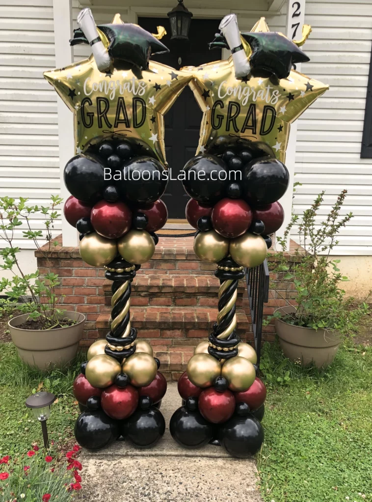 Grade cap balloon in Foil with black maroon and gold balloon with twisted balloon aranged in column to celbrate gradution in NJ