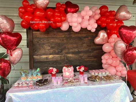 Celebrating love with pink, red latex balloons and a red heart-shaped balloon backdrop in NJ