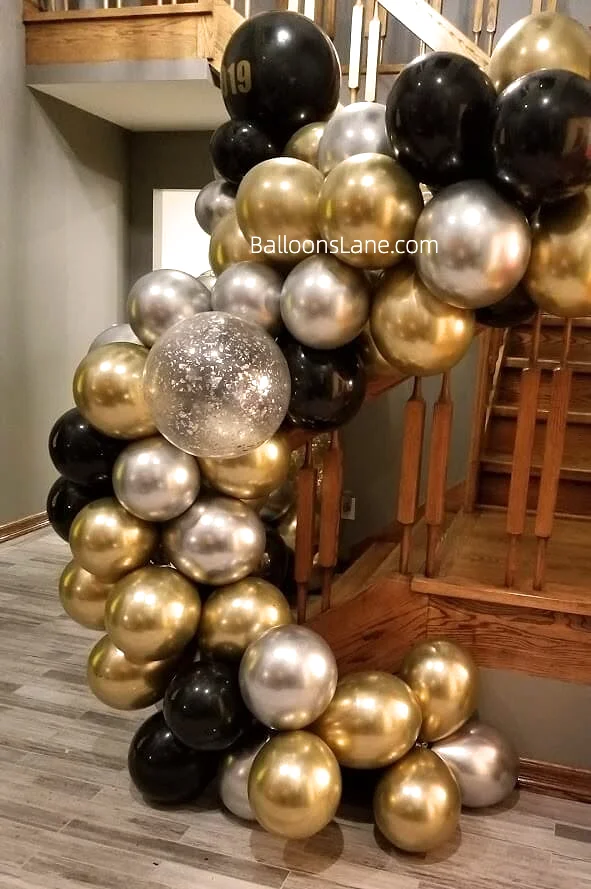 Gold, silver, and black balloons garland for celebrating engagement or prom night in NYC.