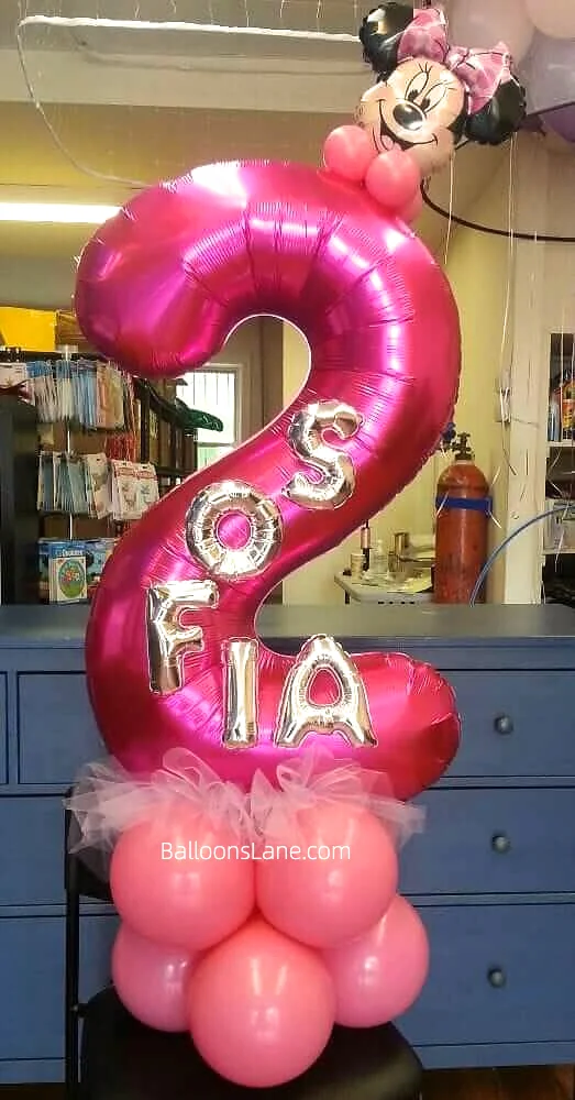 Large number balloon '2' customized with bunnies and letter balloons arranged on a balloon cluster by Balloons Lane in Manhattan