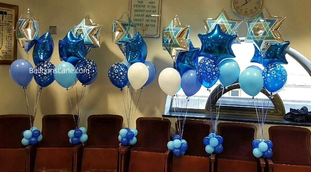 A charming bouquet of blue and white star foil balloons arranged for communion.