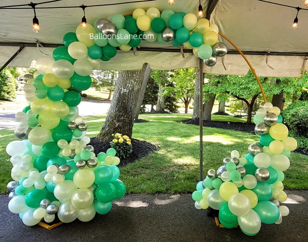 Organic balloons garland arch in lime, mint green, yellow, and bottle green balloons