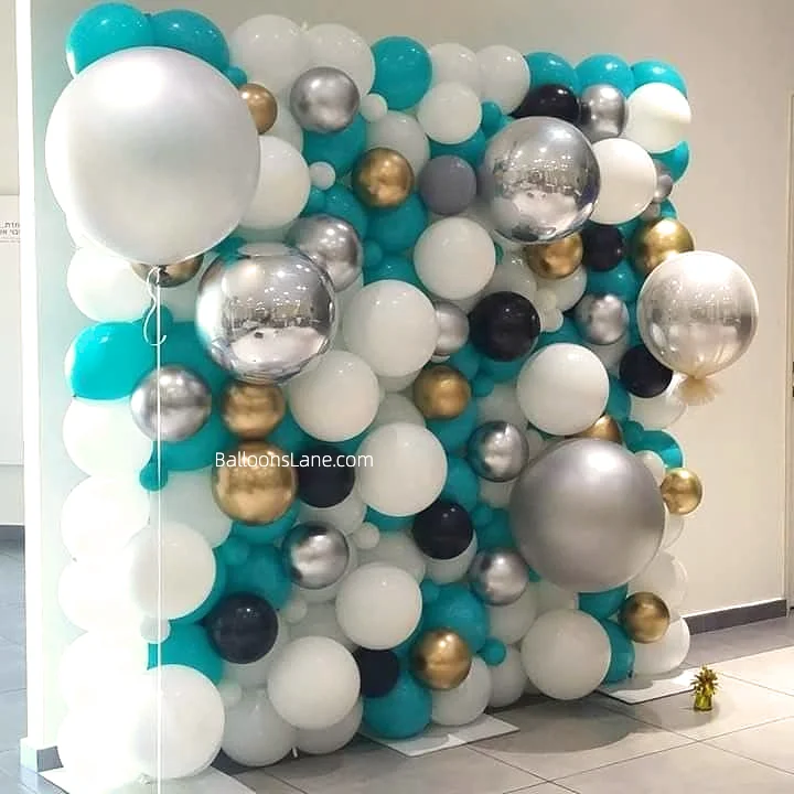 Organic balloons wall with white, chrome gold, and blue balloons in multiple sizes